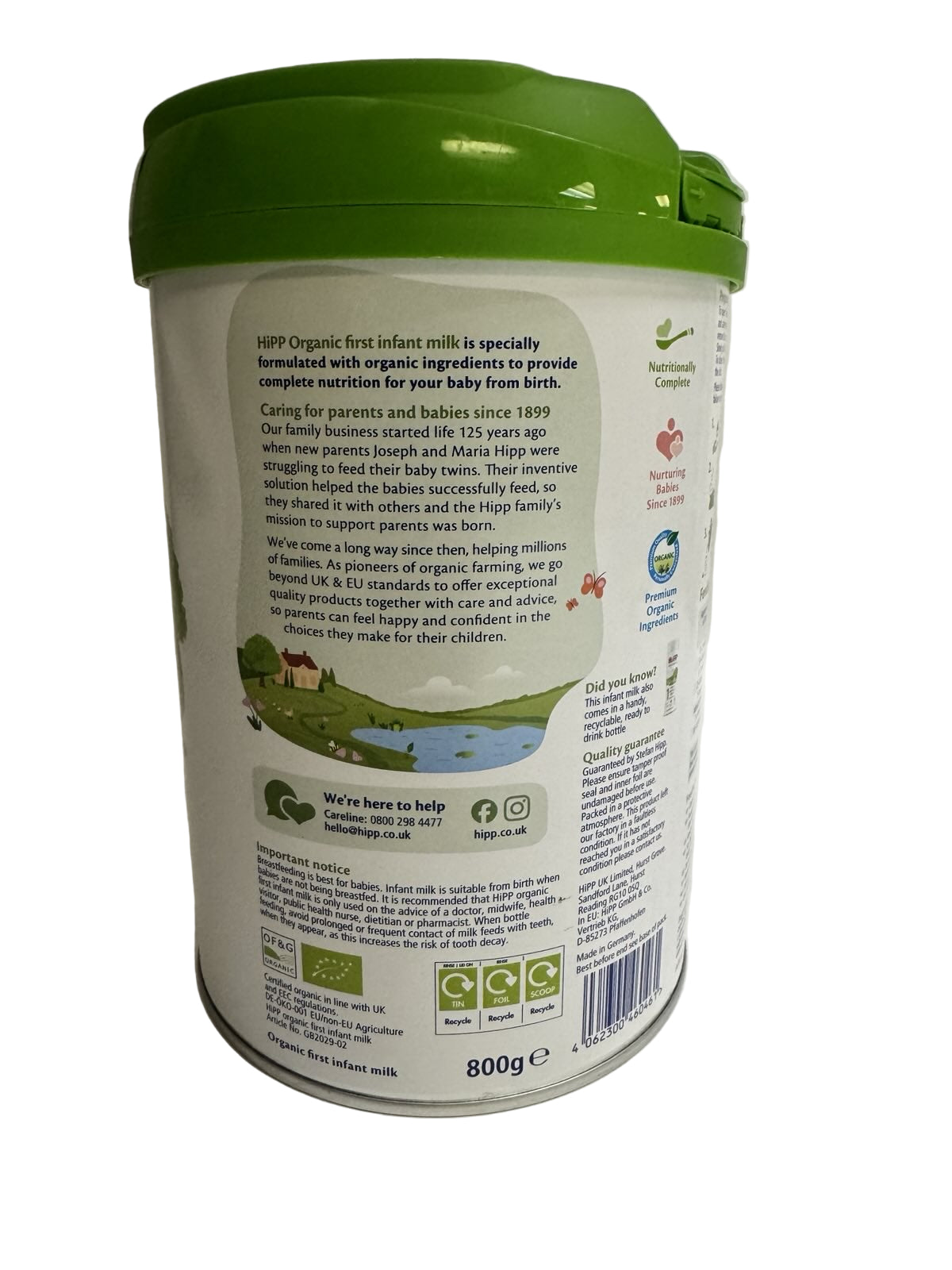 Container of HPP organic first infant milk powder with green lid on a white background