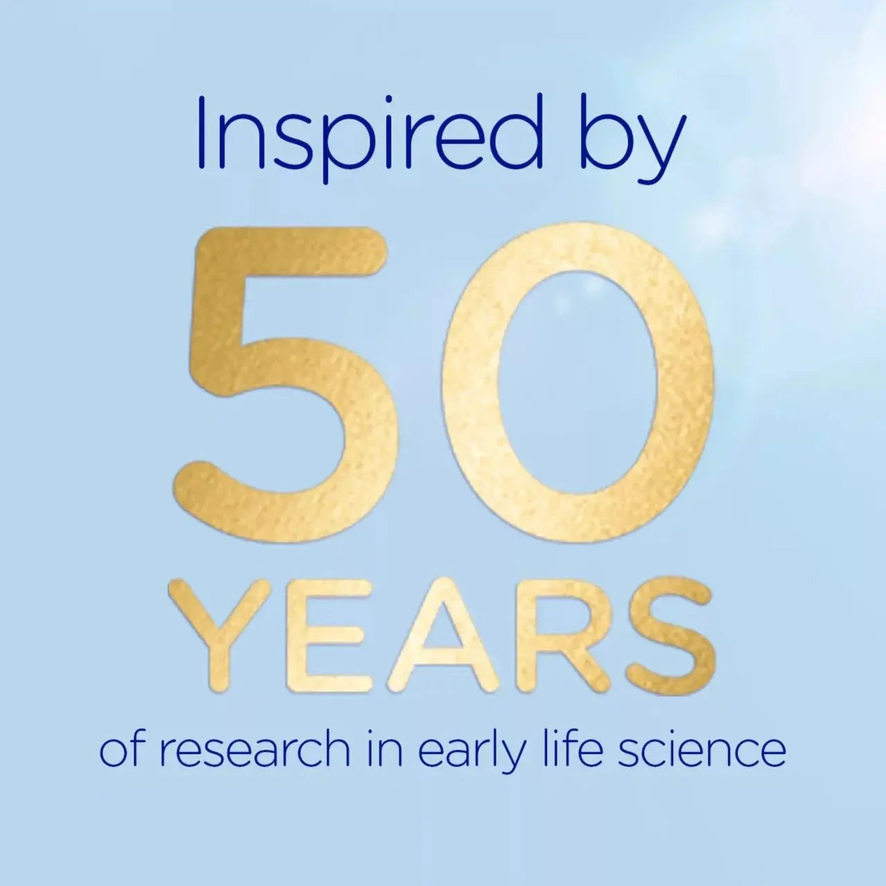 A light blue graphic with the text 'Inspired by 50 YEARS of research in early life science' in navy and metallic gold lettering.