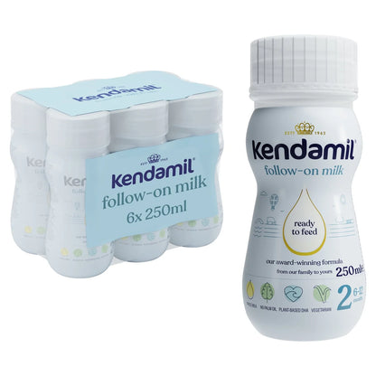 A pack of six Kendamil follow-on milk bottles in a white plastic carrier with a light blue wrap, shown next to a single bottle of the same product on a plain white background.