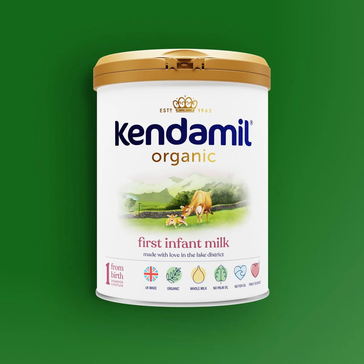 A canister of Kendamil Organic First Infant Milk, featuring a white label with blue and gold branding, set against a solid green background.