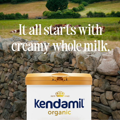 Kendamil organic milk container with a scenic background of cows and fields.