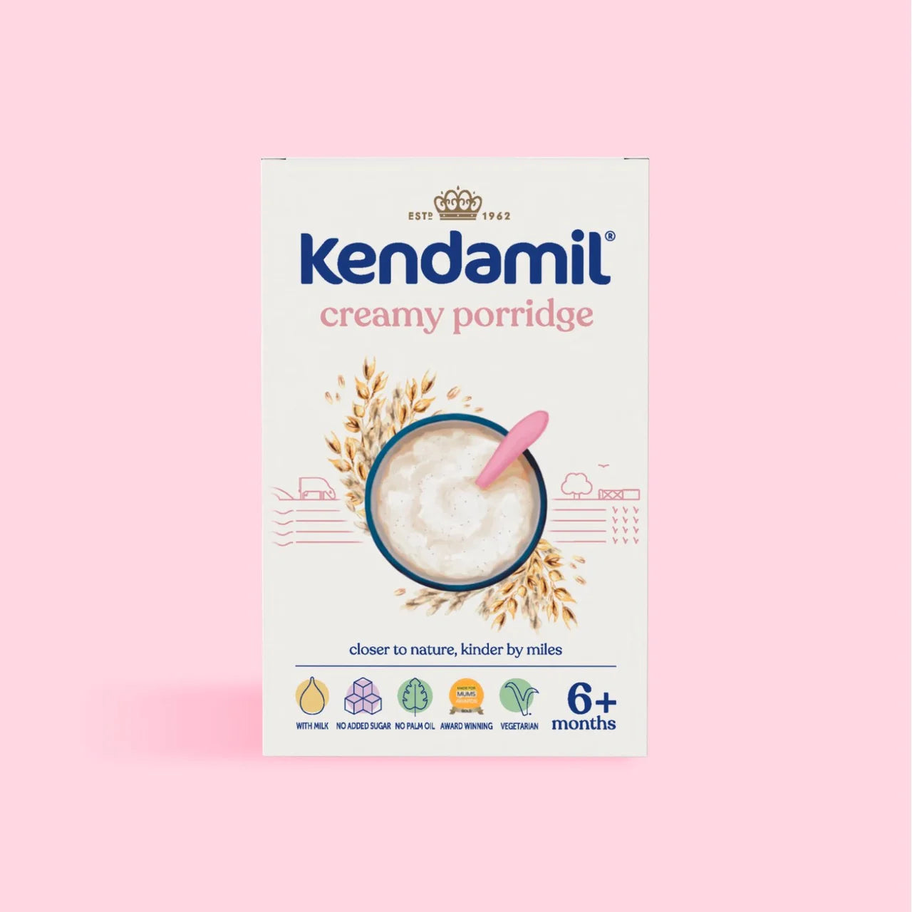 A box of Kendamil Creamy Porridge for 6+ months, featuring a white background with blue and pink text, an illustration of a bowl of porridge, and a pink spoon, set against a solid pink background.