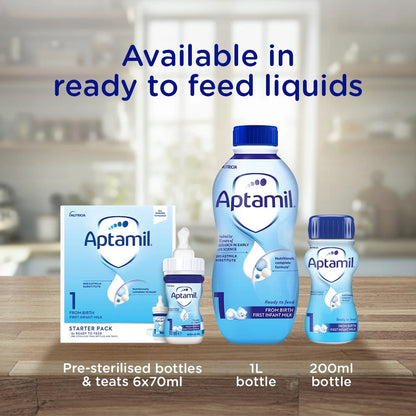 Aptamil ready-to-feed liquid bottles and teats shown on a wooden surface with a blurred kitchen background. Large blue text at the top reads 'Available in ready to feed liquids,' and text at the bottom lists starter pack, 1L bottle, and 200ml bottle sizes.