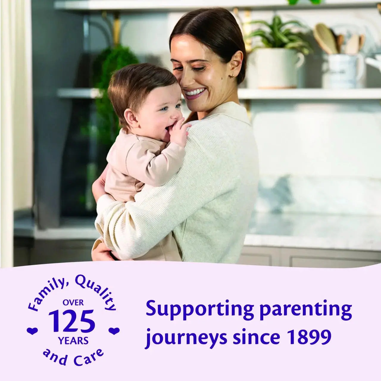 Woman holding a baby in a kitchen with text about supporting parenting journeys since 1899.