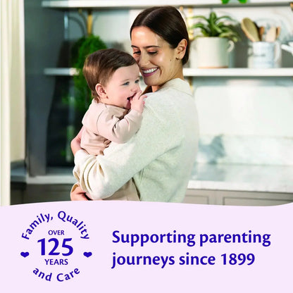 Woman holding a baby in a kitchen with text about supporting parenting journeys since 1899.