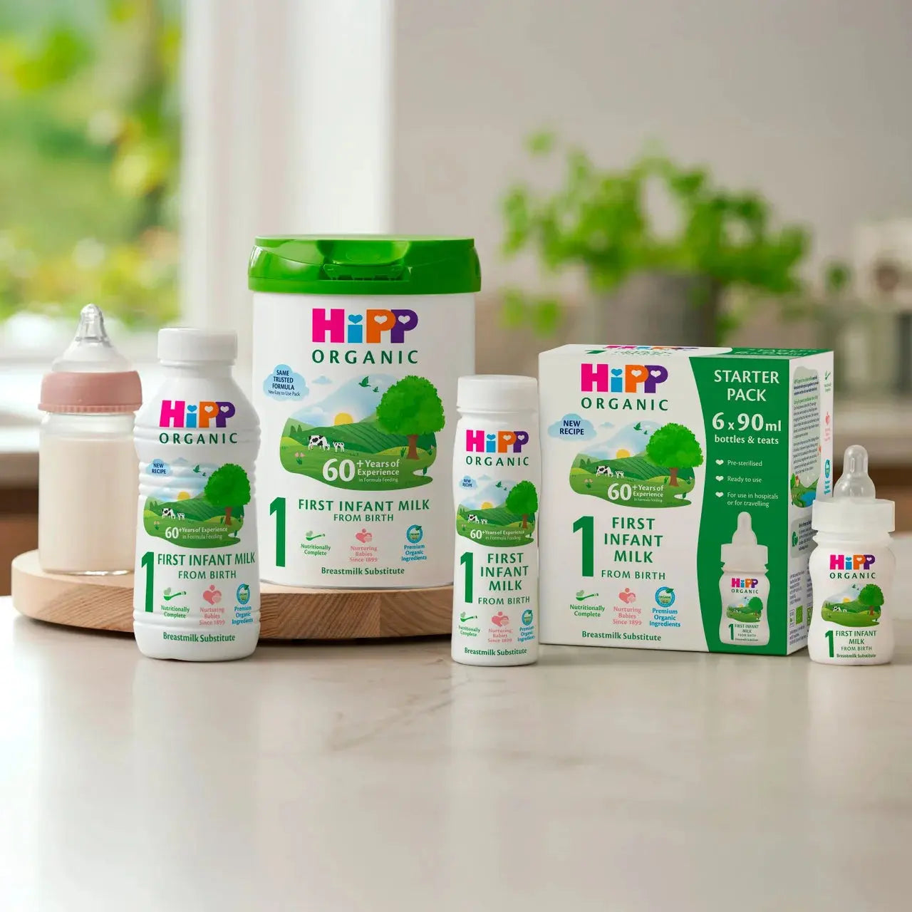Hipp Organic baby milk products on a table with a blurred background