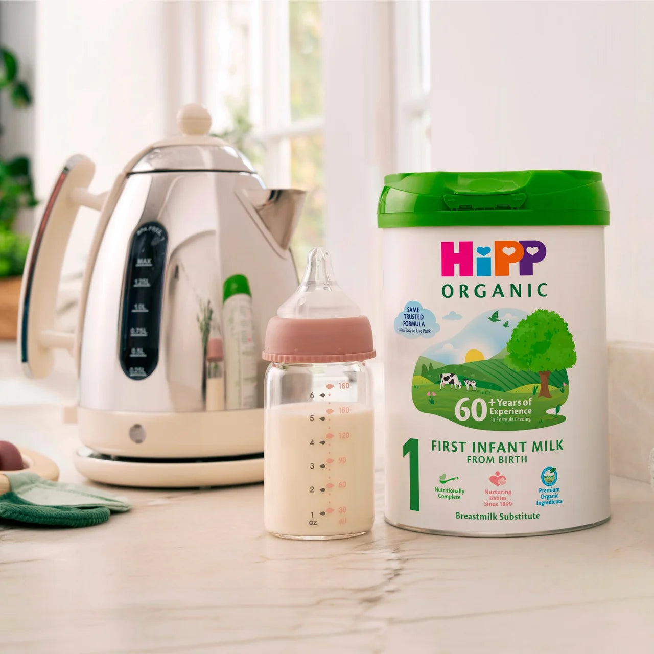 Hipp Organic First Infant Milk container with a bottle on a kitchen counter