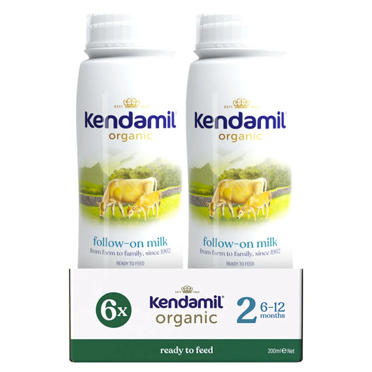Two bottles of Kendamil organic follow-on milk with a box in the foreground on a white background.