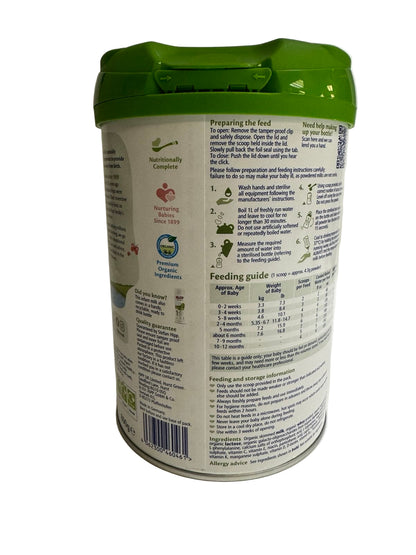 Back view of a baby formula can with green lid on a white background