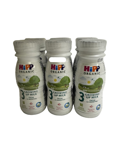 Six bottles of HiPP Organic Growing Up Milk on a white background