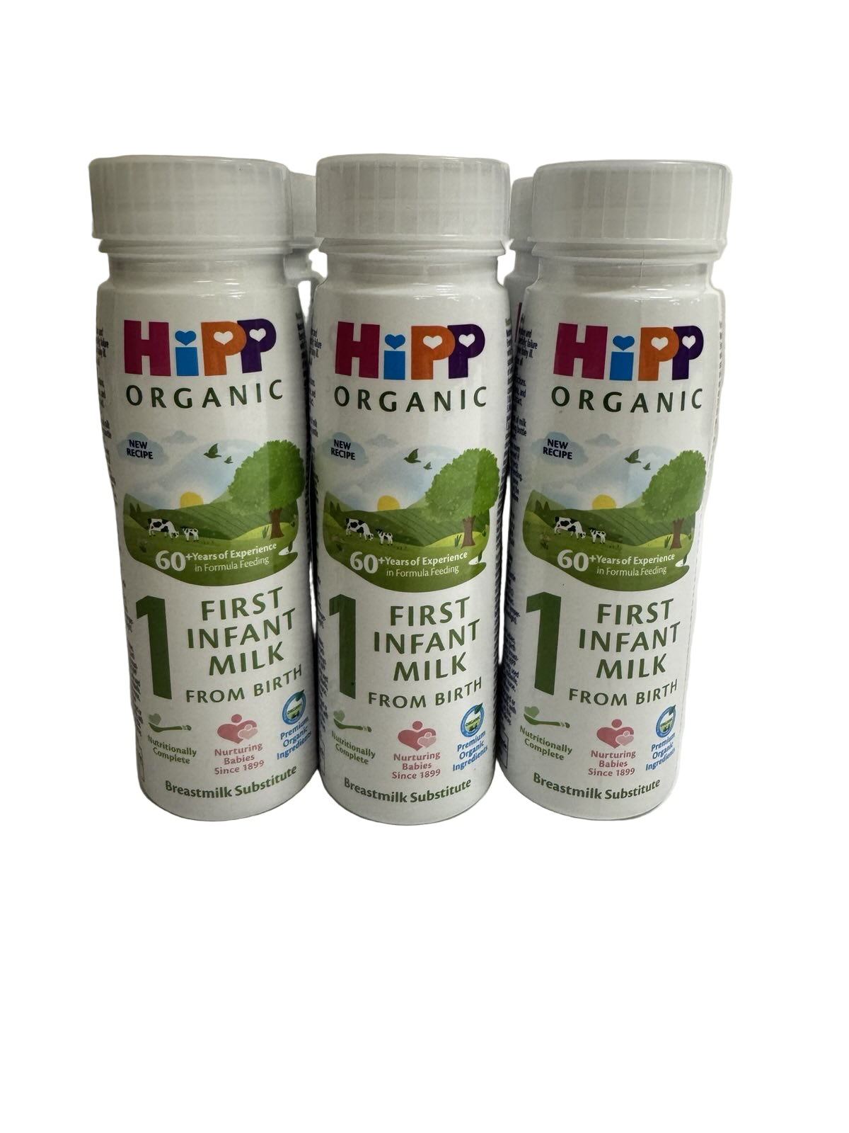 Six Hipp Organic First Infant Ready to Feed Milk bottles on a plain background